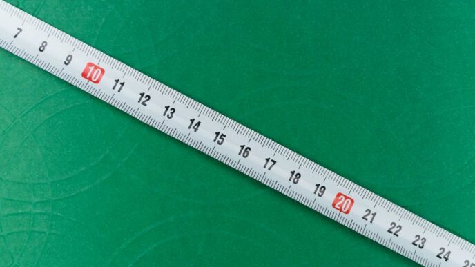 white ruler on green textile