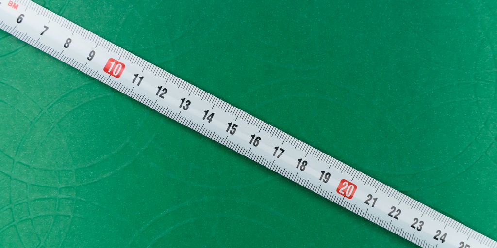 white ruler on green textile