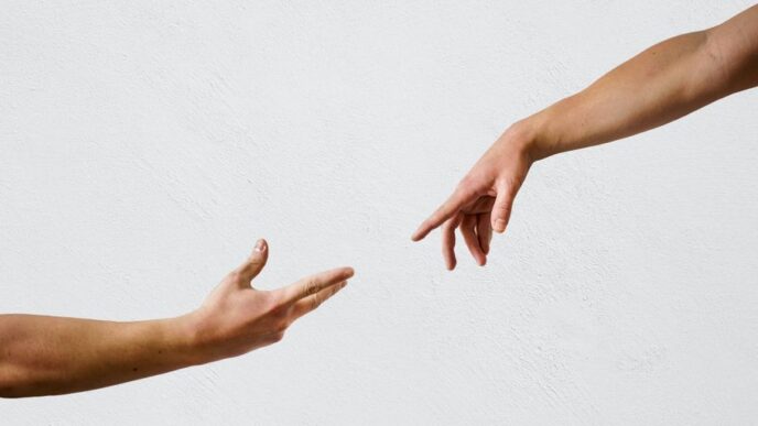 persons hand on white wall