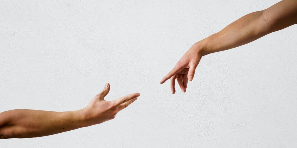 persons hand on white wall