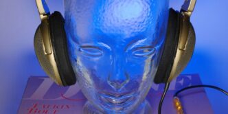 a glass head with headphones on top of it