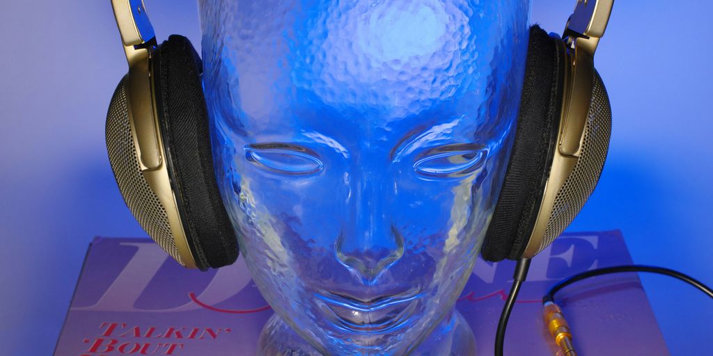 a glass head with headphones on top of it