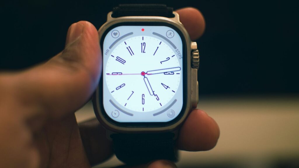a person holding a smart watch in their hand