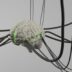A computer generated image of a brain surrounded by wires