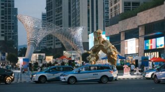 a giant statue of a giant creature in the middle of a city