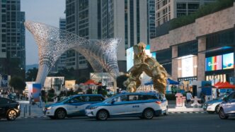 a giant statue of a giant creature in the middle of a city
