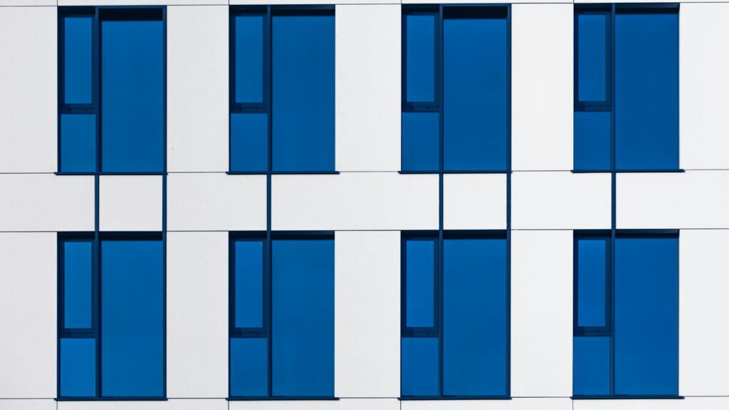 a white and blue building with blue windows