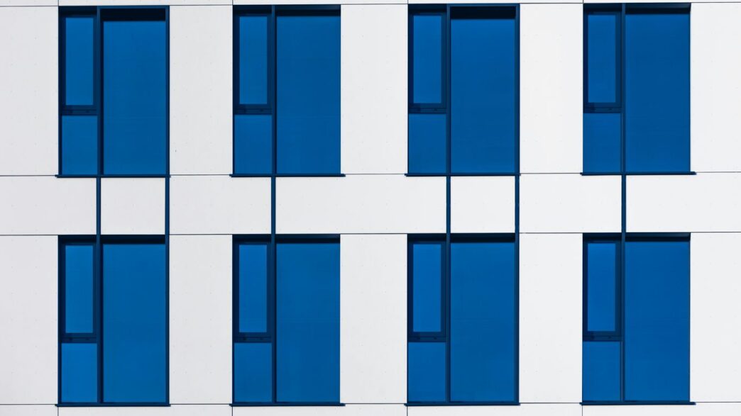 a white and blue building with blue windows