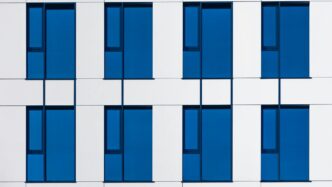 a white and blue building with blue windows