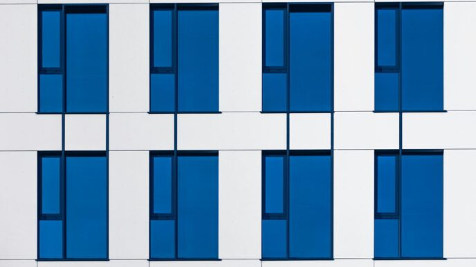 a white and blue building with blue windows