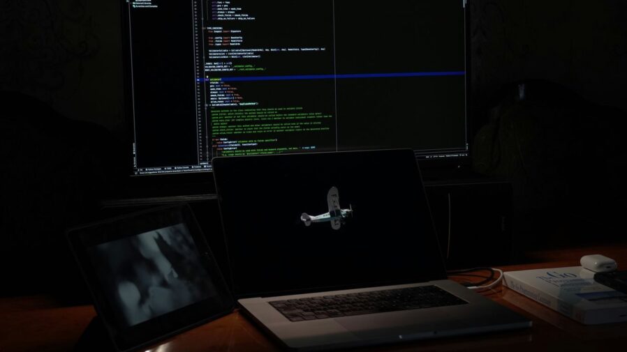 a laptop computer sitting on top of a wooden desk