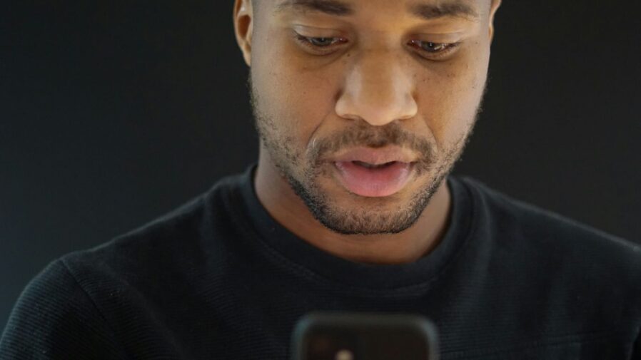 a close up of a person looking at a cell phone