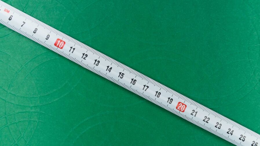 white ruler on green textile