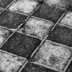 a black and white photo of a cobblestone road