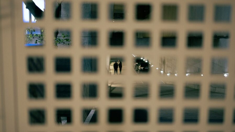 A close up of a window with a reflection of a building