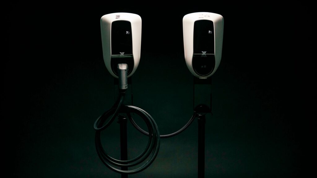 a couple of black and white phones on a black background