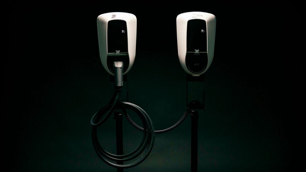 a couple of black and white phones on a black background