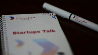 a notebook with a pen sitting on top of it