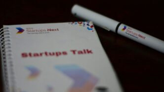 a notebook with a pen sitting on top of it