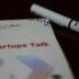 a notebook with a pen sitting on top of it