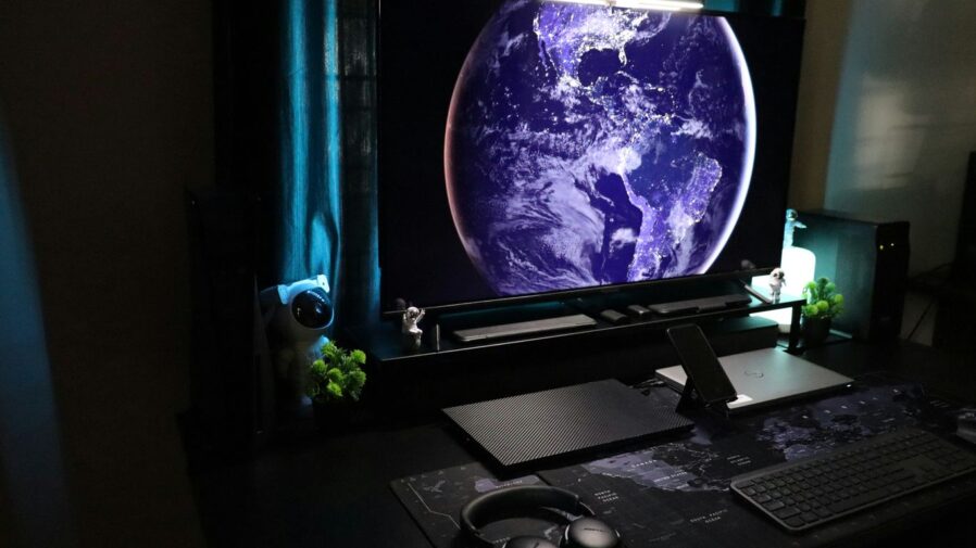 A computer desk with a monitor and keyboard