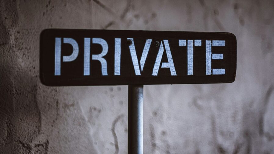 grayscale photo of black and white wooden sign