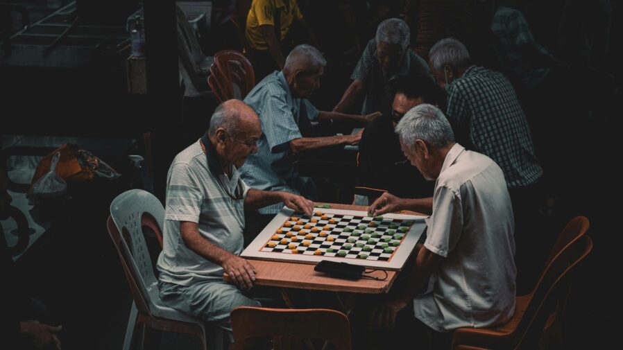a group of older men playing a game of chess
