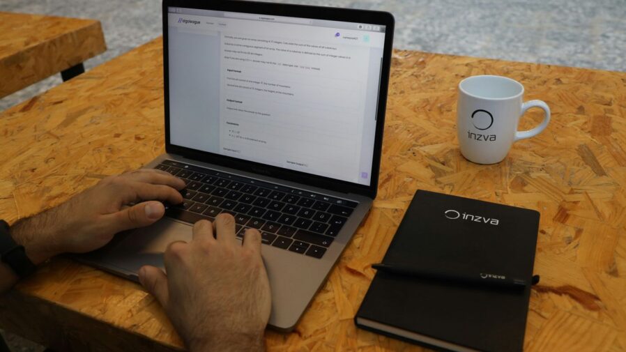 a person sitting at a table with a laptop