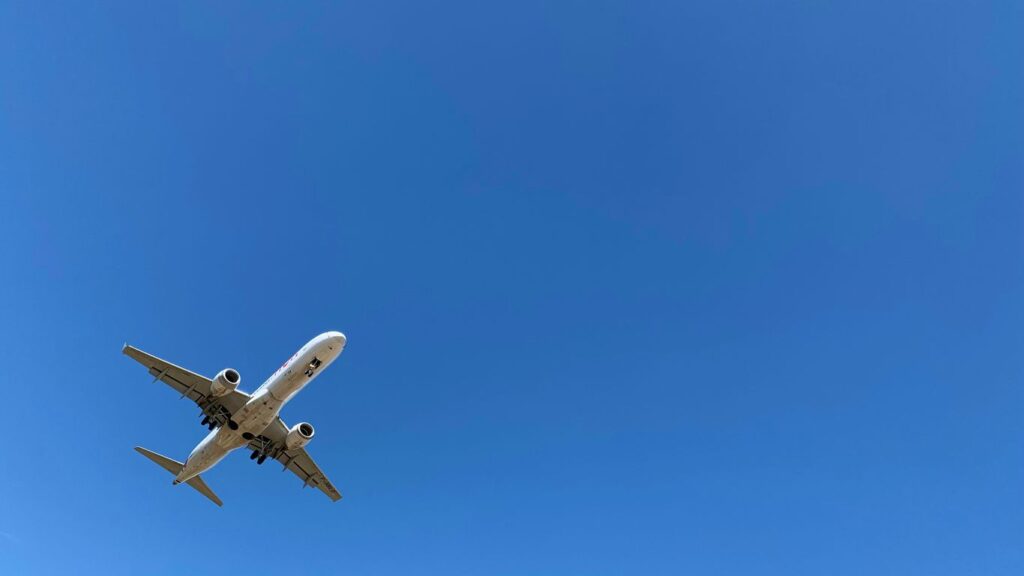 a large jetliner flying through a blue sky