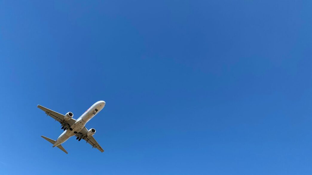 a large jetliner flying through a blue sky