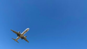 a large jetliner flying through a blue sky