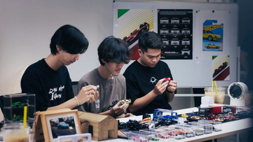 Three people focused on a table with items