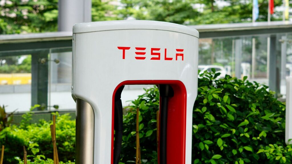 a close up of a red and white tesla charging station