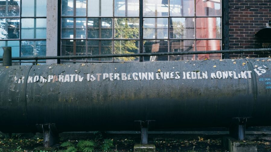 a large metal tank sitting in front of a building