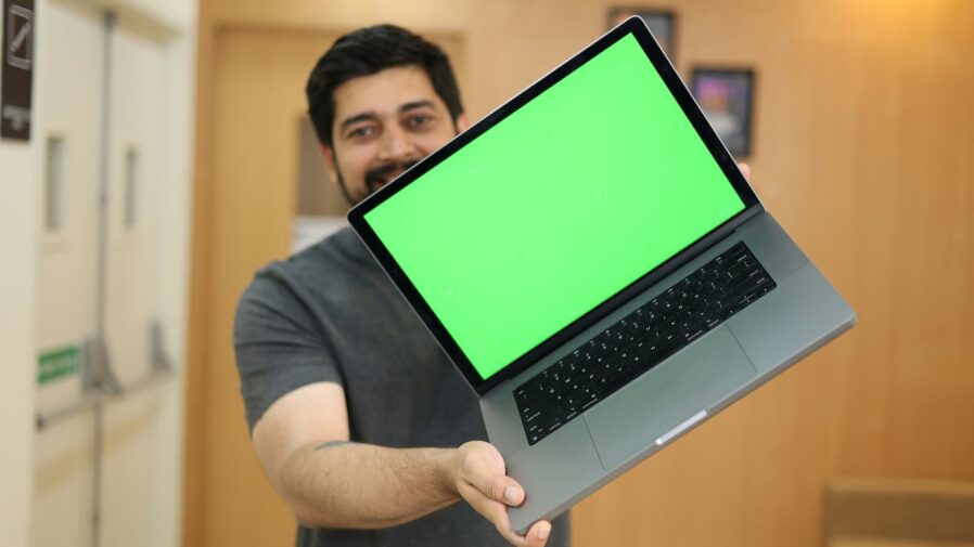 a man holding a laptop