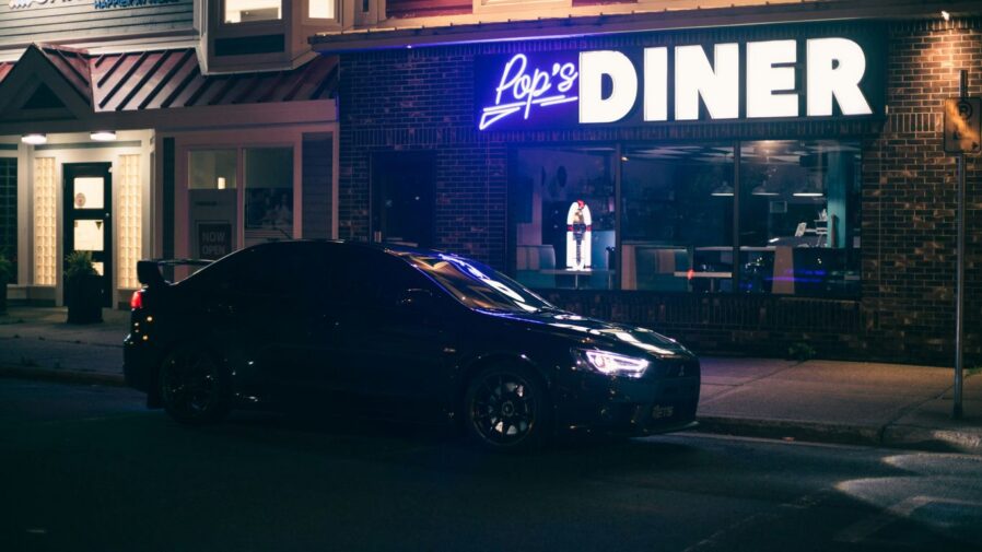 a black car parked outside a building