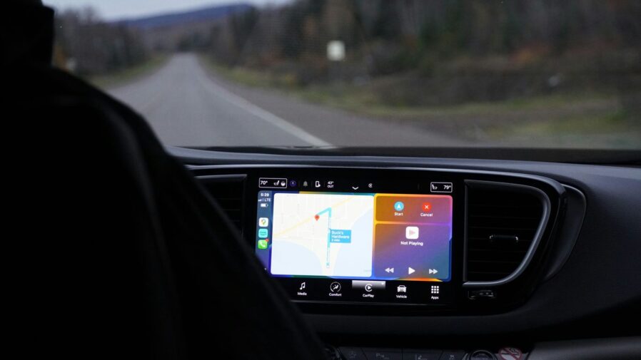 a man driving a car with a gps device in his hand
