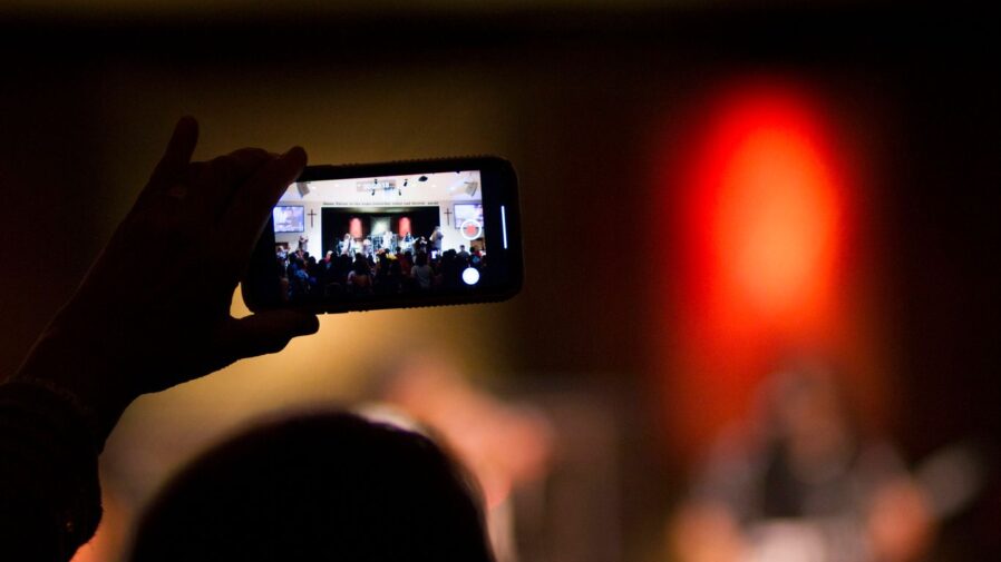 selective focus photography of person holding smartphone