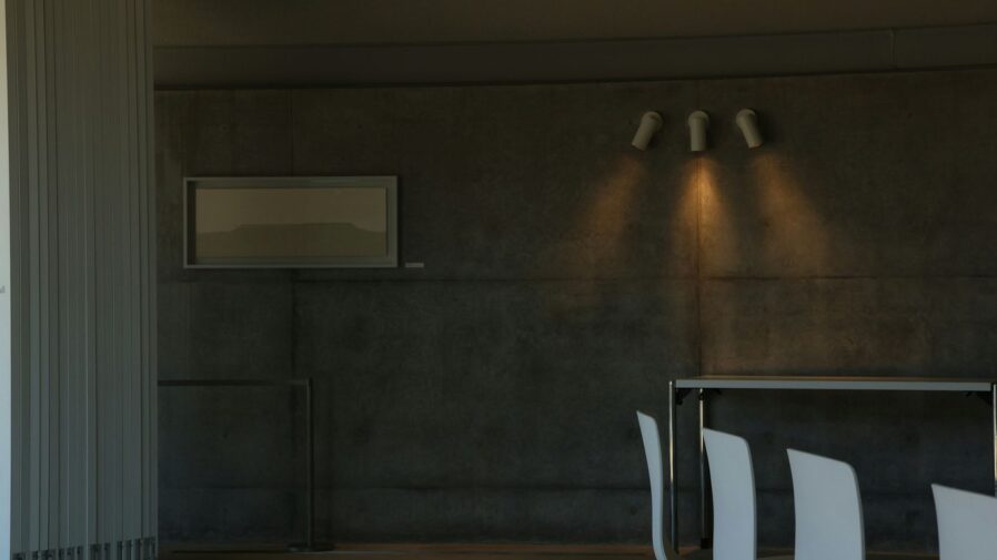 A modern dining room with lights and chairs.