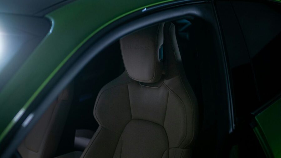 The interior of a green sports car with its lights on
