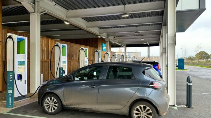 a silver car is parked at a gas station