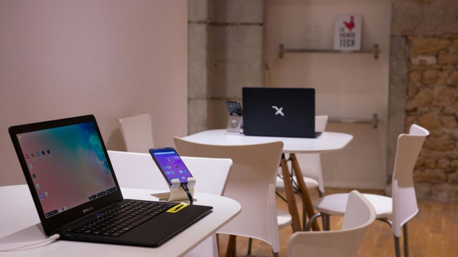 black laptop computer on white wooden table