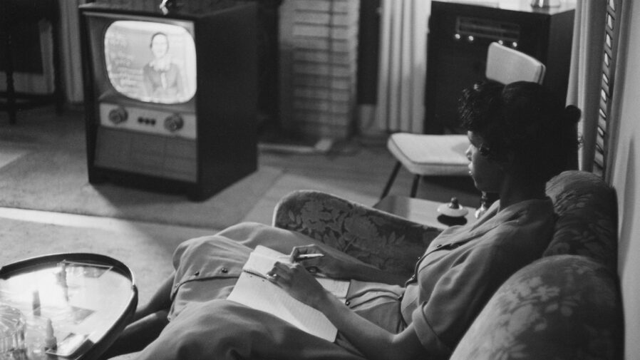 An African American high school girl being educated via television during the period that the Little Rock schools were closed to avoid integration. 