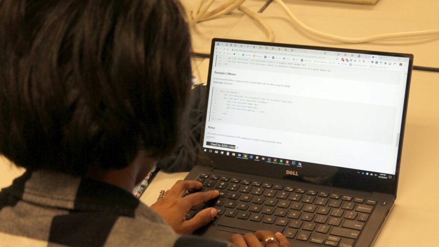 a person sitting in front of a laptop computer
