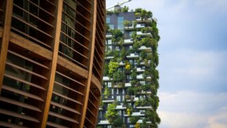 a very tall building with a bunch of plants growing on it
