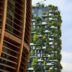 a very tall building with a bunch of plants growing on it