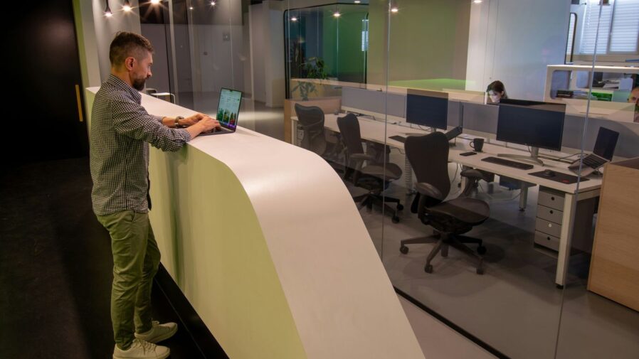 a man standing at a desk in an office