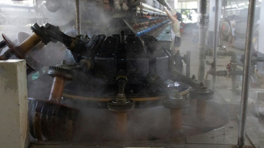 Steam rises from an industrial machine.