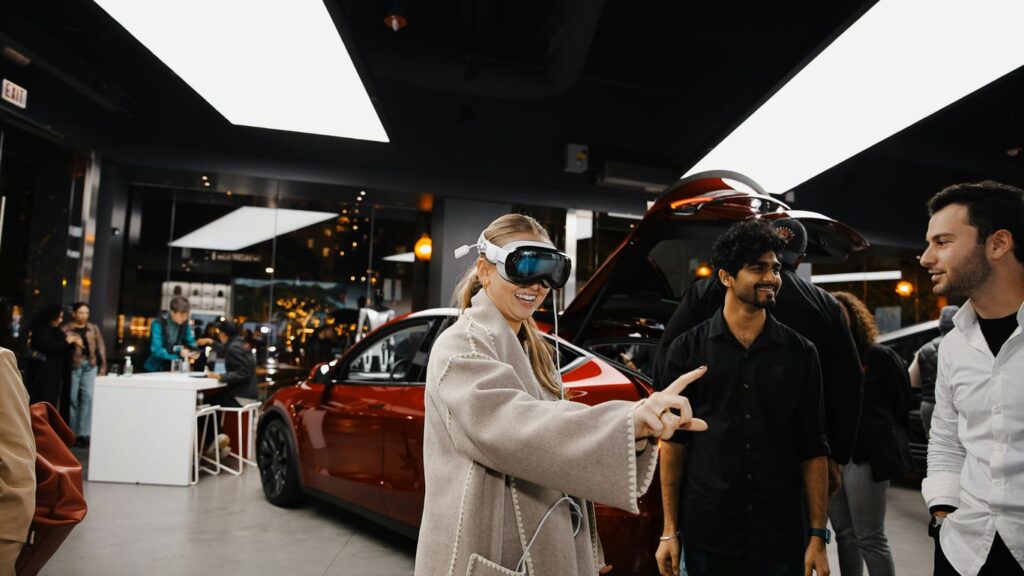 A group of people standing around a car showroom
