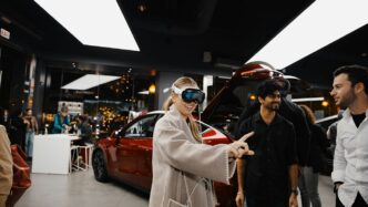 A group of people standing around a car showroom